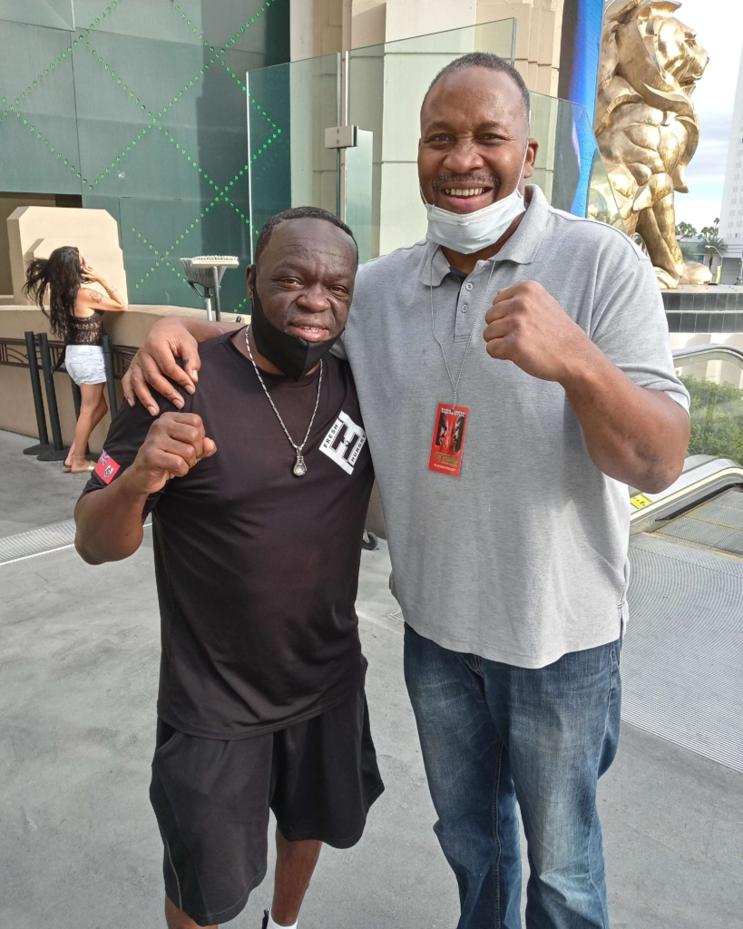 Jeff Mayweather standing with Tim Witherspoon